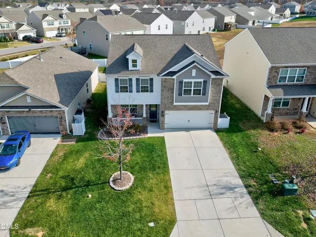 a view of a house with a backyard and a patio
