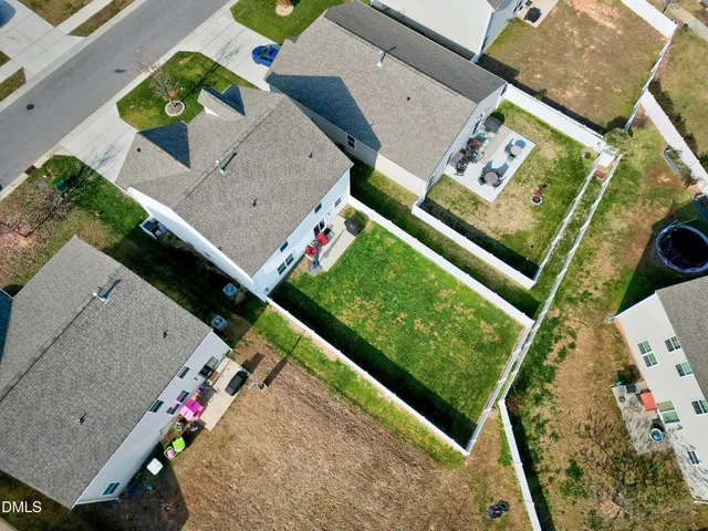 an aerial view of a residential houses with outdoor space