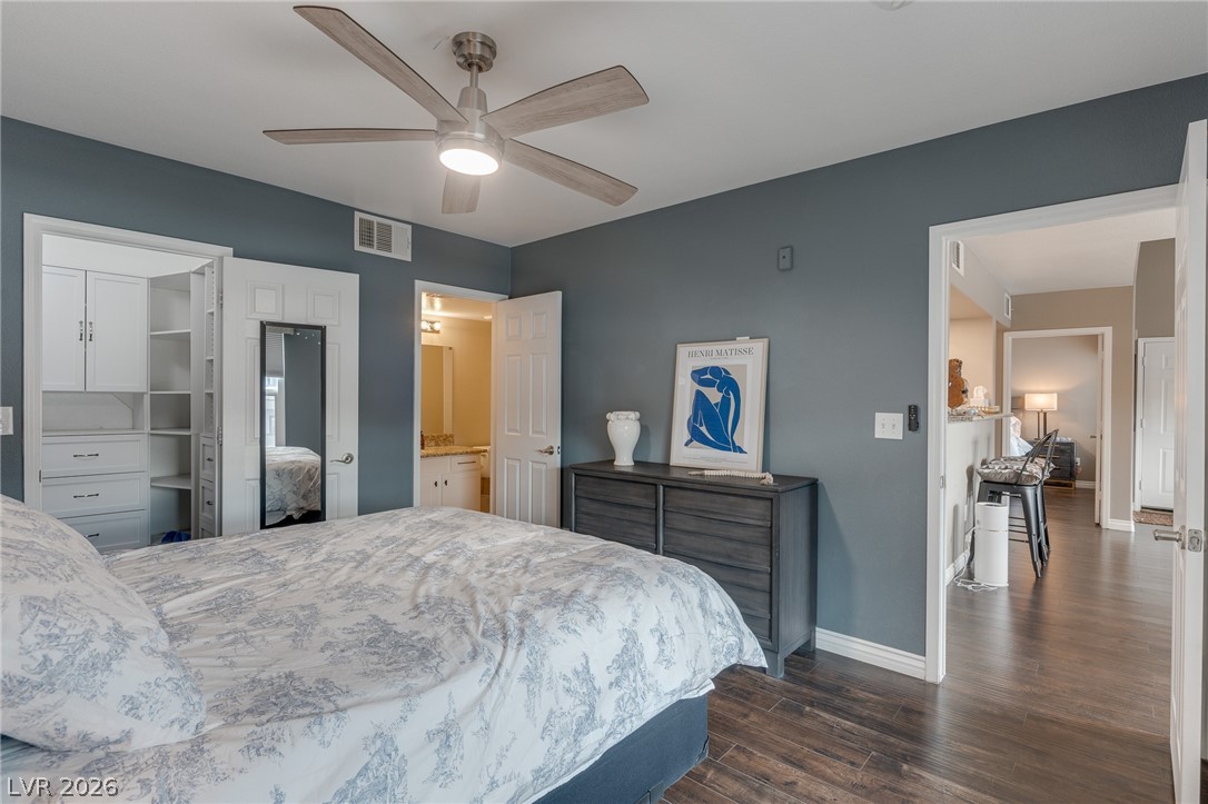7255 West Sunset Road, Unit 2155 Las Vegas, NV 89113 - Photo 13 of 21 Bedroom with dark wood-type flooring, a ceiling fan, and connected bathroom