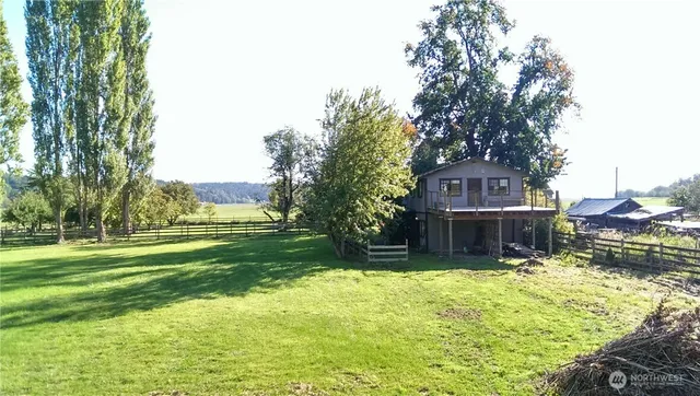 a view of yard with swimming pool and trees