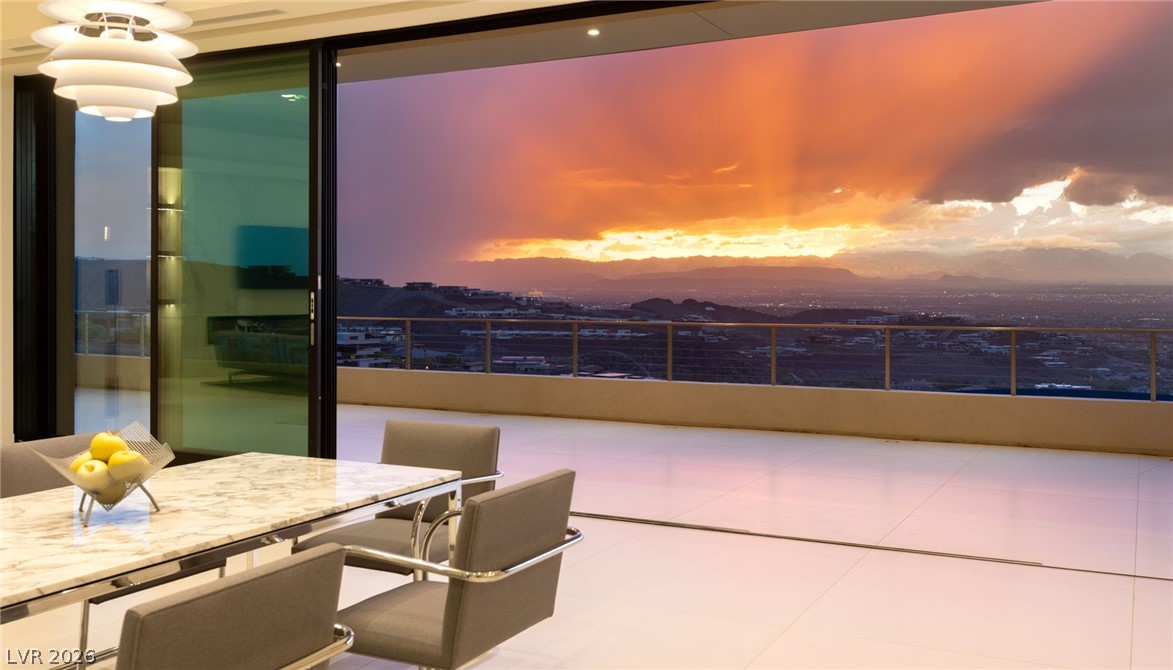 677 Overlook Rim Drive Henderson, NV 89012 - Photo 12 of 97 Massive sliding glass walls open completely to a terrace with panoramic valley views.