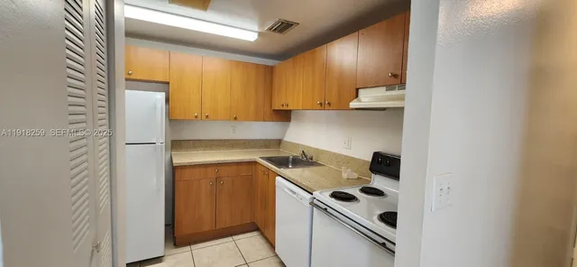 a kitchen with a sink and a refrigerator
