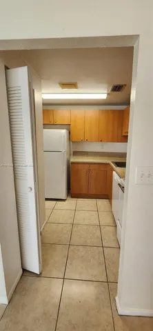 a kitchen with a refrigerator