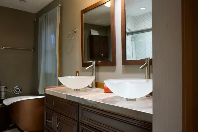 a bathroom with a granite countertop sink and a mirror
