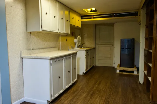 a kitchen with stainless steel appliances granite countertop a sink a stove and refrigerator