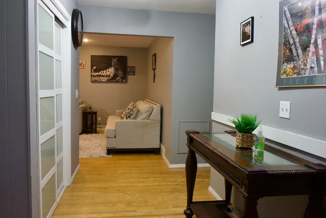 a living room with furniture and wooden floor
