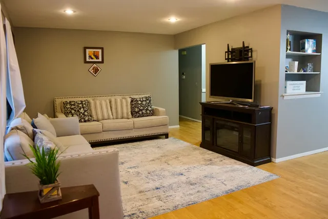 a living room with furniture and a flat screen tv