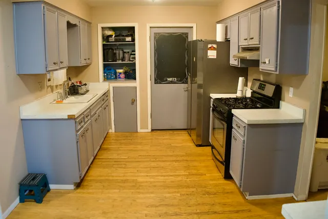 a kitchen with stainless steel appliances a stove refrigerator sink and cabinets