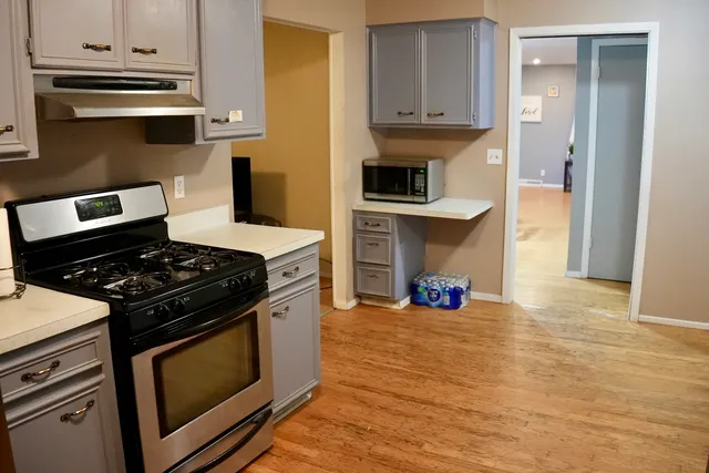a kitchen with stainless steel appliances a stove and a refrigerator