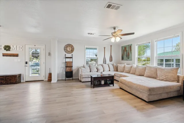a living room with furniture and wooden floor