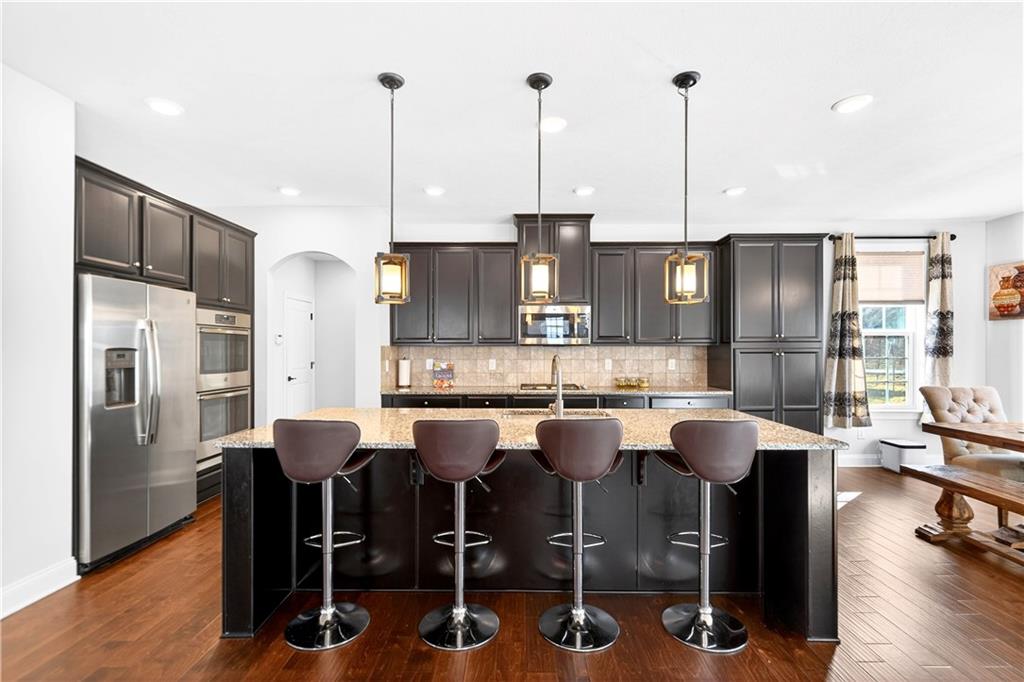 1444 Main Street Pittsburgh, PA 15241 - Photo 12 of 50 a view of kitchen with stainless steel appliances kitchen island granite countertop dining table chairs and granite counter tops