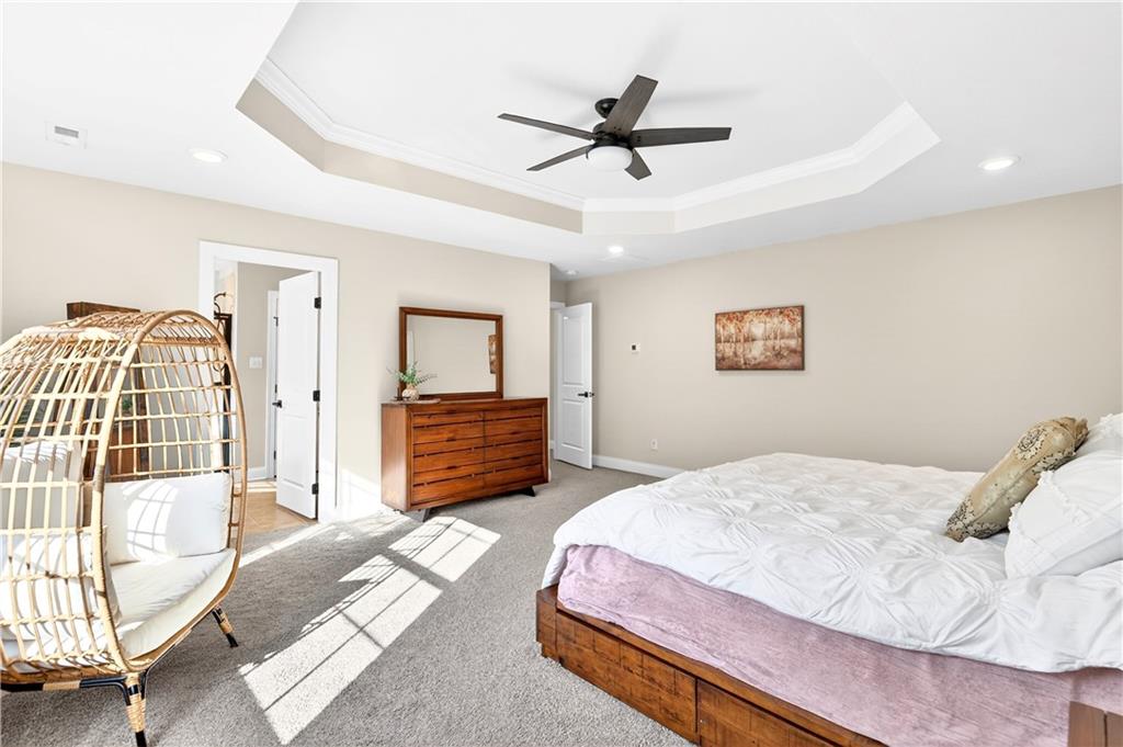 1444 Main Street Pittsburgh, PA 15241 - Photo 33 of 50 a spacious bedroom with a bed a dresser and a chandelier