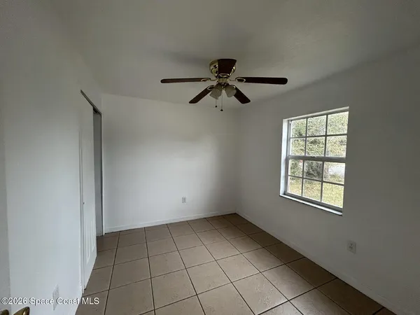 a view of an empty room with a window