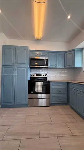 a kitchen with stainless steel appliances a stove and a refrigerator