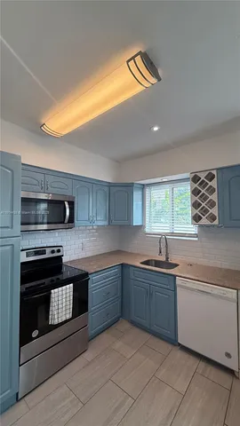 a kitchen with stainless steel appliances granite countertop a sink and stove top oven