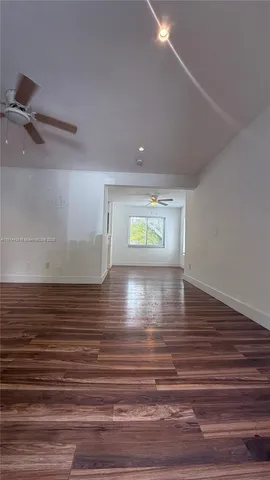 a view of room with window and wooden floor