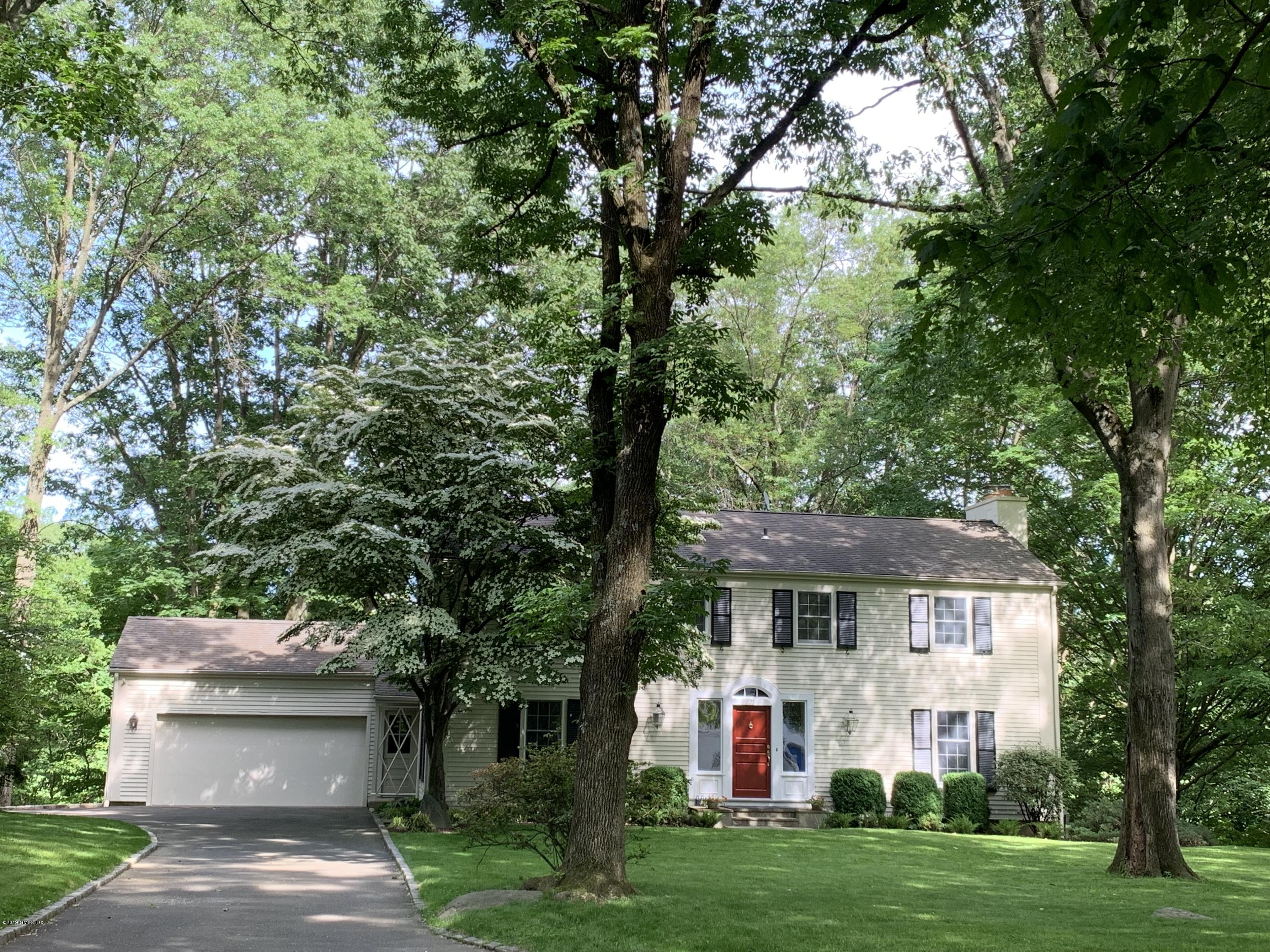 25 Harkim Road Greenwich, CT 06831 - Photo 1 of 14 a front view of a house with a garden