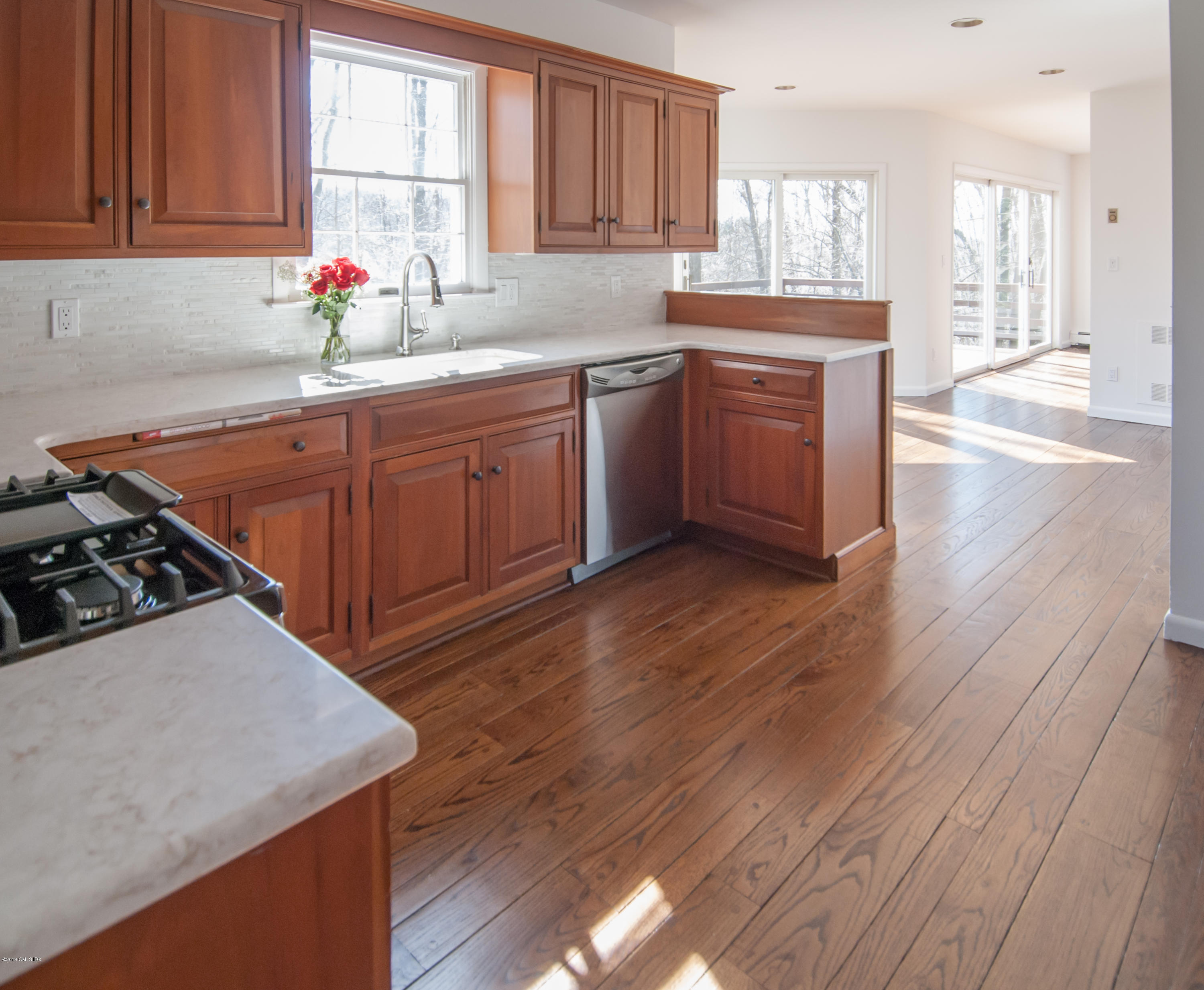 25 Harkim Road Greenwich, CT 06831 - Photo 3 of 14 a kitchen with stainless steel appliances a sink dishwasher stove and wooden cabinets
