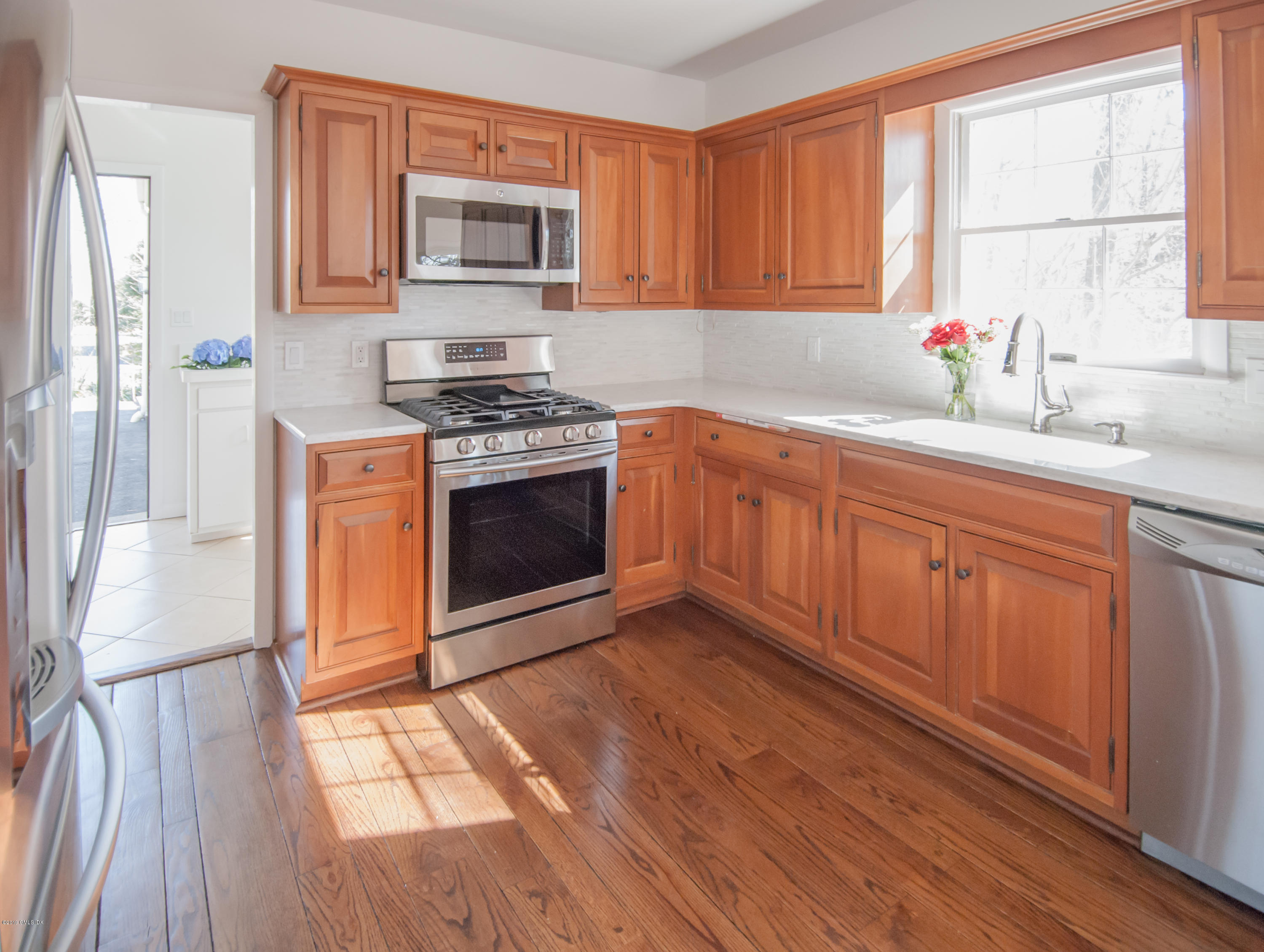 25 Harkim Road Greenwich, CT 06831 - Photo 4 of 14 a kitchen with stainless steel appliances granite countertop a stove a sink and a refrigerator