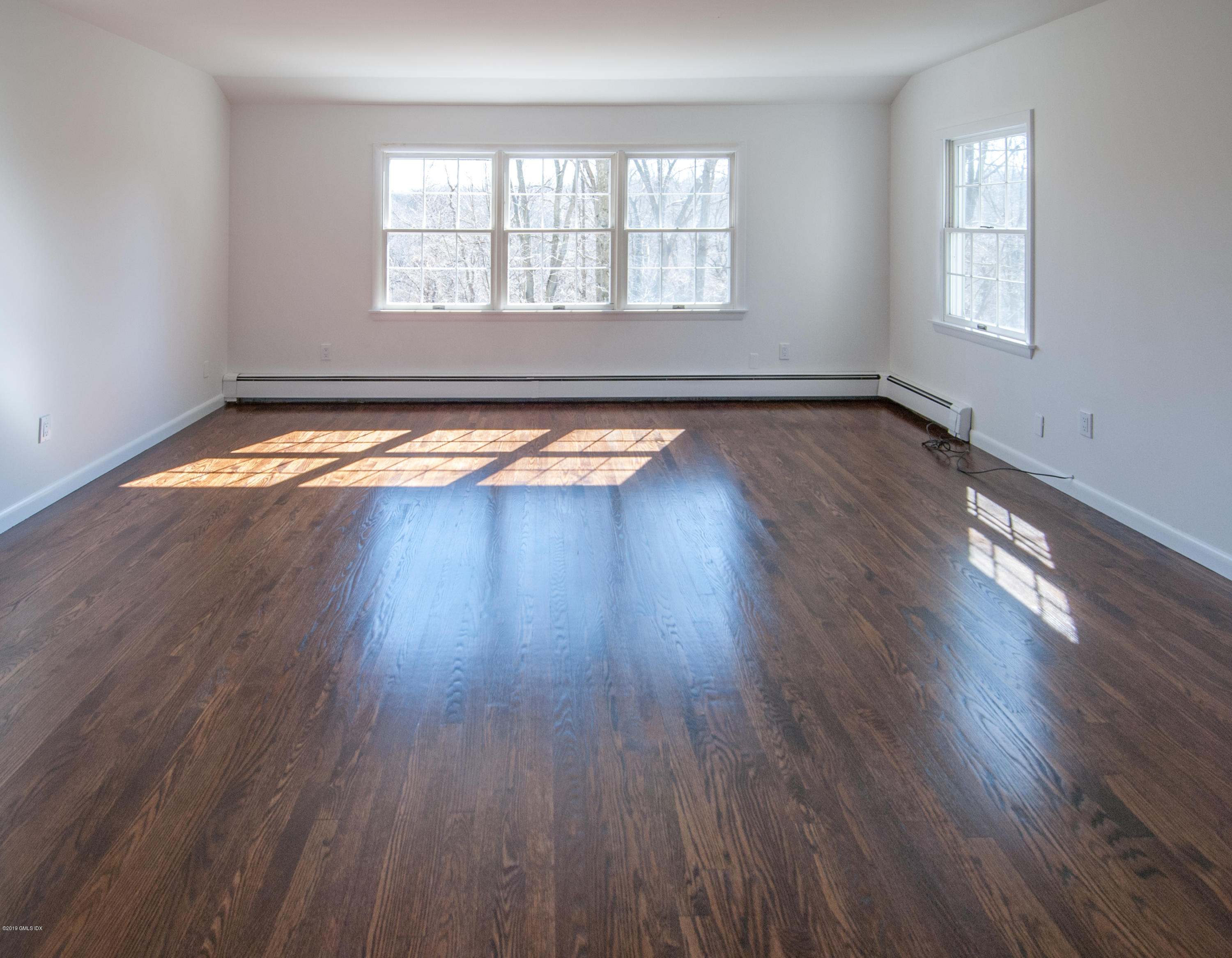 25 Harkim Road Greenwich, CT 06831 - Photo 8 of 14 a view of empty room with wooden floor and fan