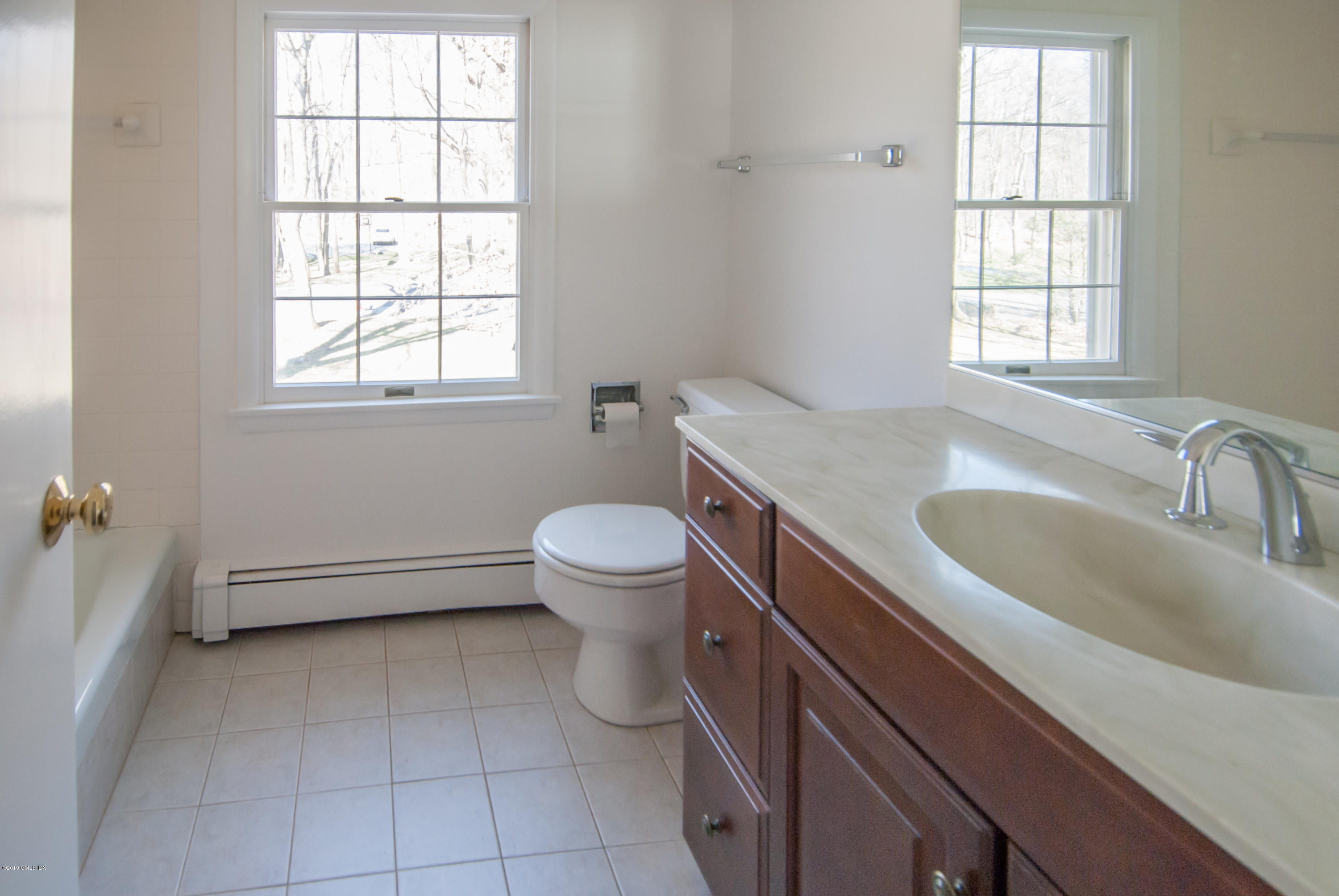 25 Harkim Road Greenwich, CT 06831 - Photo 10 of 14 a bathroom with a sink toilet and window