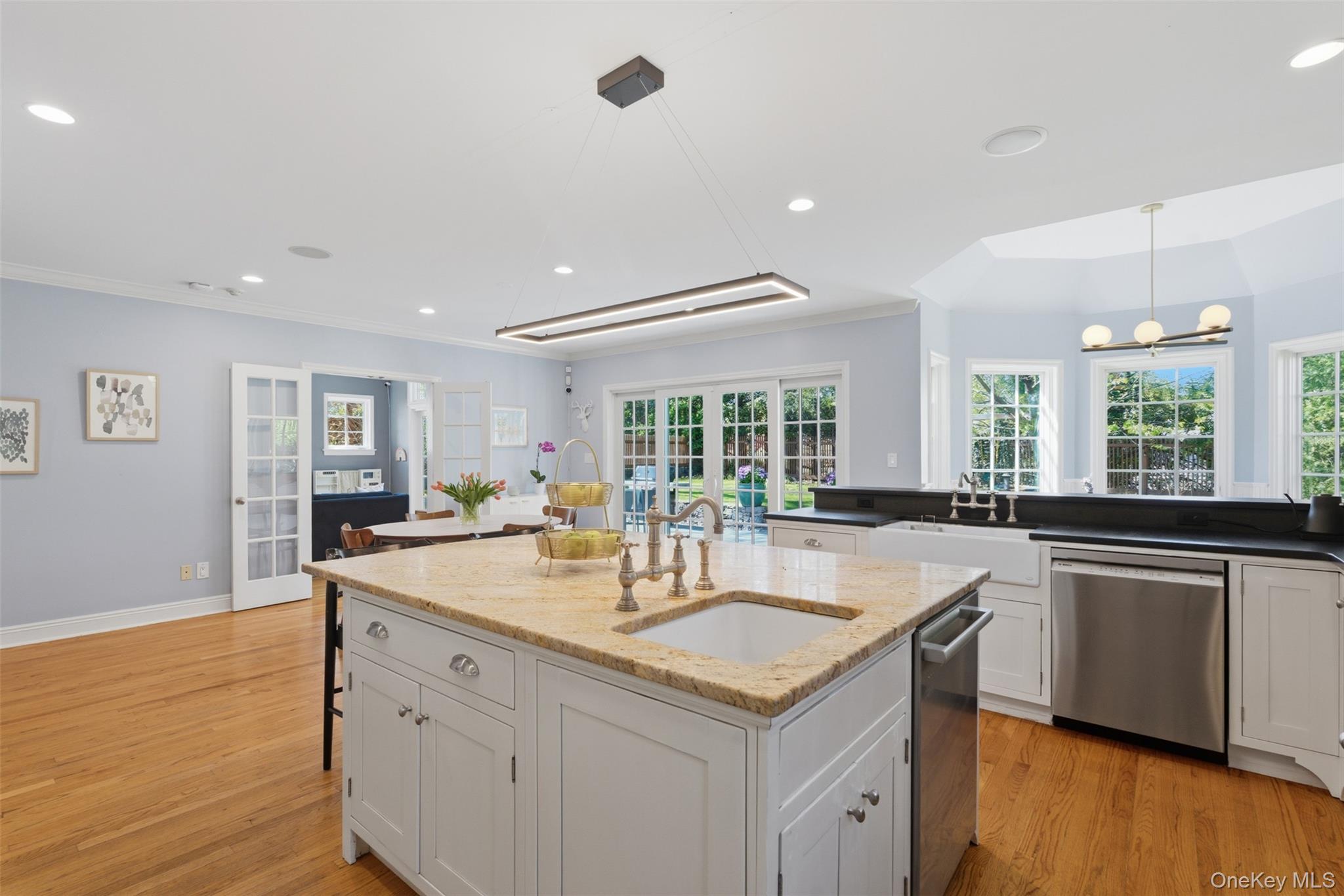 42 Mulberry Lane New Rochelle, NY 10804 - Photo 15 of 43 a kitchen with granite countertop a sink and cabinets with wooden floor