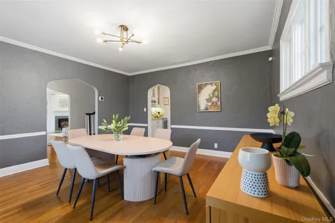 a view of a dining room with furniture wooden floor and chandelier