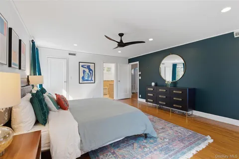 a bed room with a bed mirror and a night stand