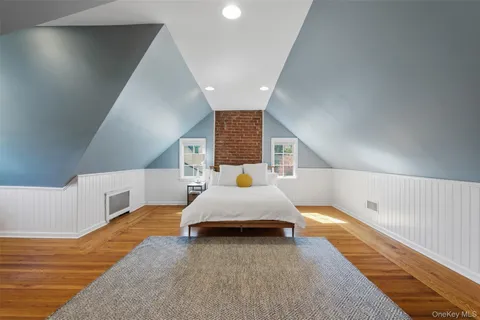 a spacious bedroom with a bed and window