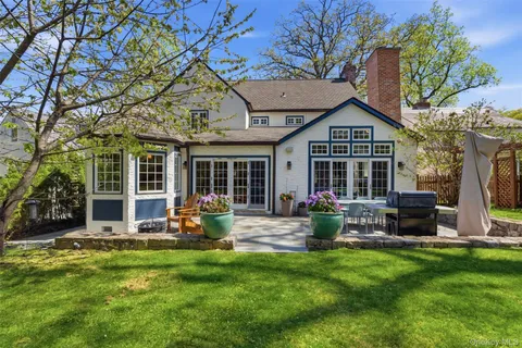 a front view of house with yard and outdoor seating