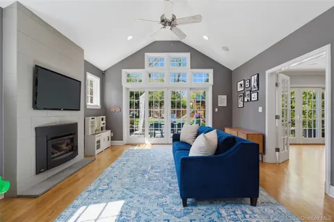 a living room with furniture a flat screen tv and a fireplace