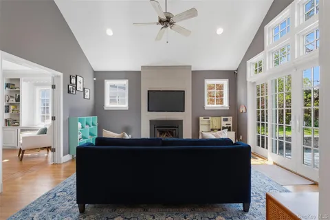 a living room with fireplace furniture and a flat screen tv