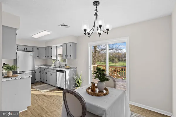 a kitchen with a table and chairs in it