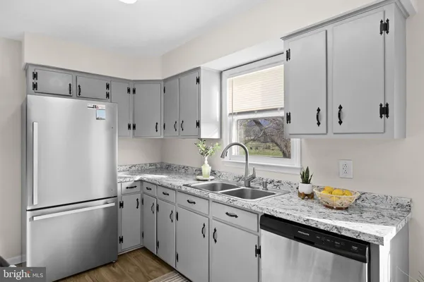 a kitchen with appliances a sink and cabinets