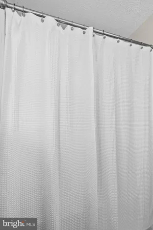 a bathroom with a shower curtain and a curtain