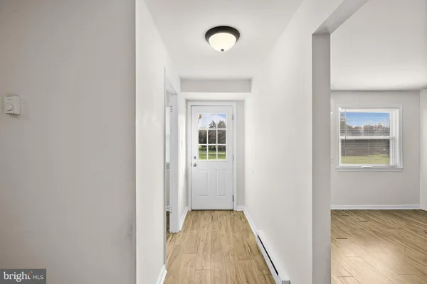 a view of a hallway with wooden floor