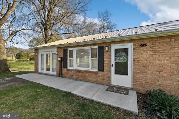 a view of a house with a yard and wooden fence