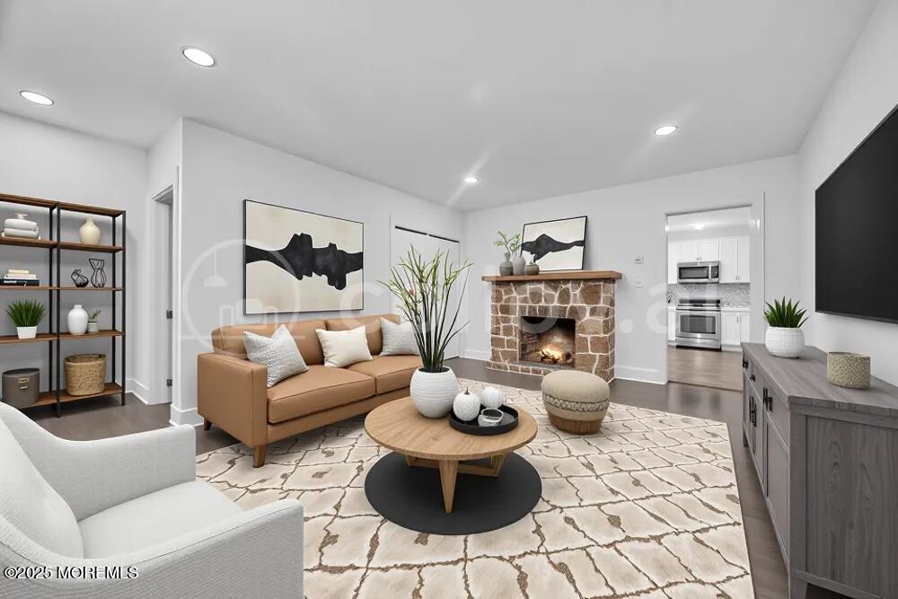 717 Holmdel Road Holmdel, NJ 07733 - Photo 11 of 39 a living room with furniture a flat screen tv and a fireplace
