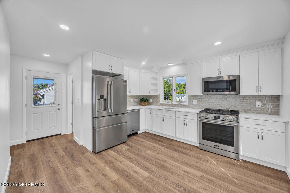717 Holmdel Road Holmdel, NJ 07733 - Photo 12 of 39 a kitchen with granite countertop a refrigerator stove and oven