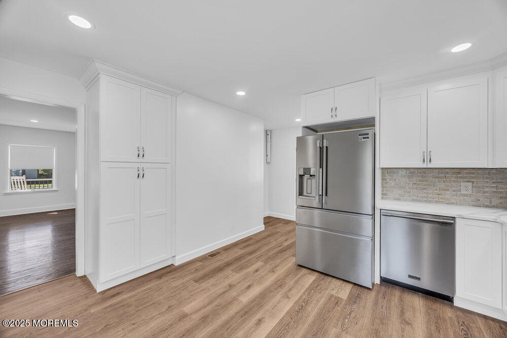 717 Holmdel Road Holmdel, NJ 07733 - Photo 14 of 39 a kitchen with cabinets and stainless steel appliances