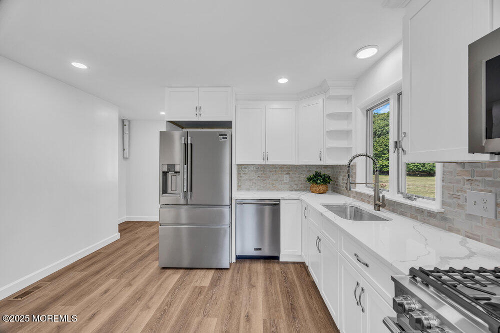 717 Holmdel Road Holmdel, NJ 07733 - Photo 15 of 39 a kitchen with a refrigerator and a sink