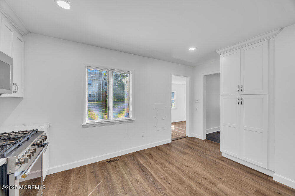 717 Holmdel Road Holmdel, NJ 07733 - Photo 16 of 39 a view of an empty room with wooden floor and a window