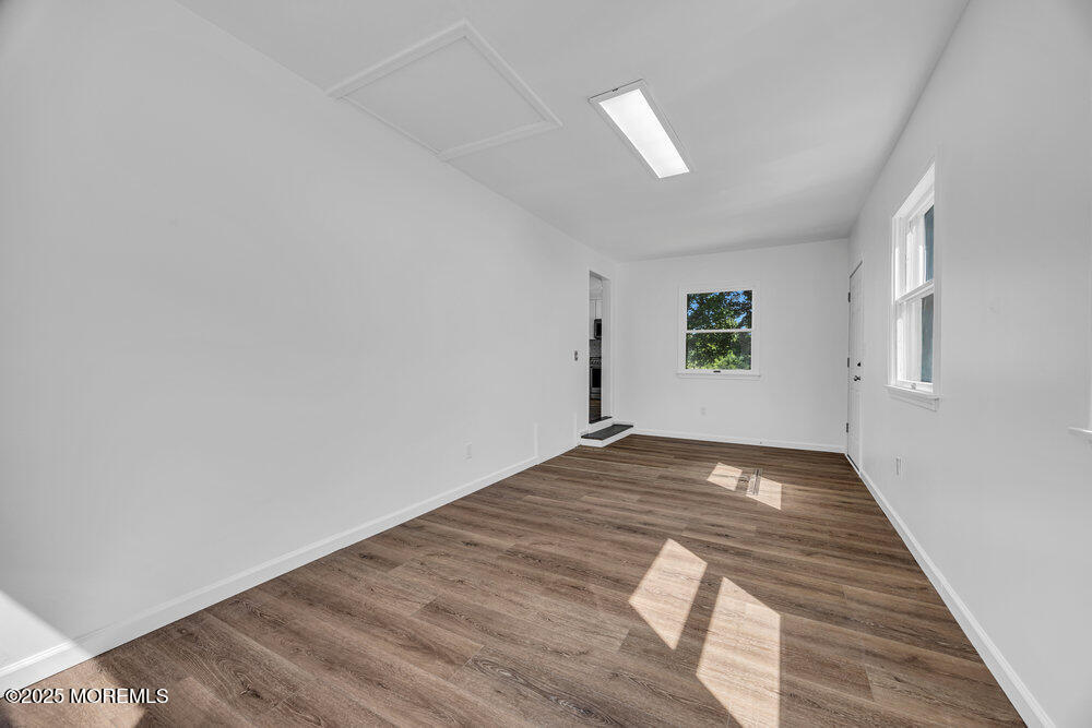 717 Holmdel Road Holmdel, NJ 07733 - Photo 18 of 39 a view of empty room with wooden floor and fan