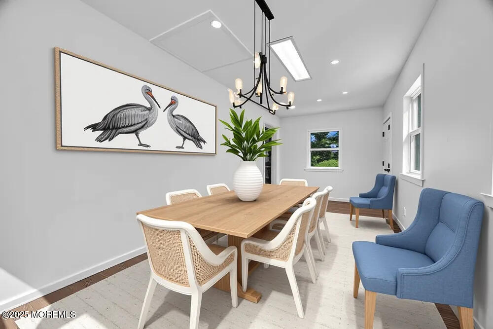 717 Holmdel Road Holmdel, NJ 07733 - Photo 20 of 39 a view of a dining room with furniture a potted plant and wooden floor