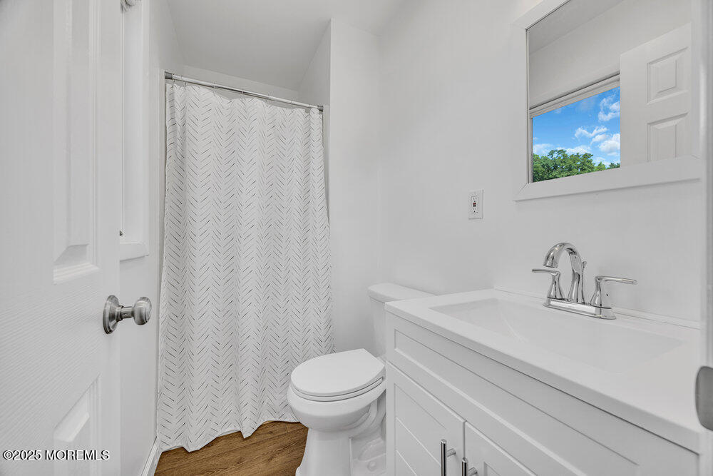 717 Holmdel Road Holmdel, NJ 07733 - Photo 22 of 39 a bathroom with a sink a toilet and shower curtain