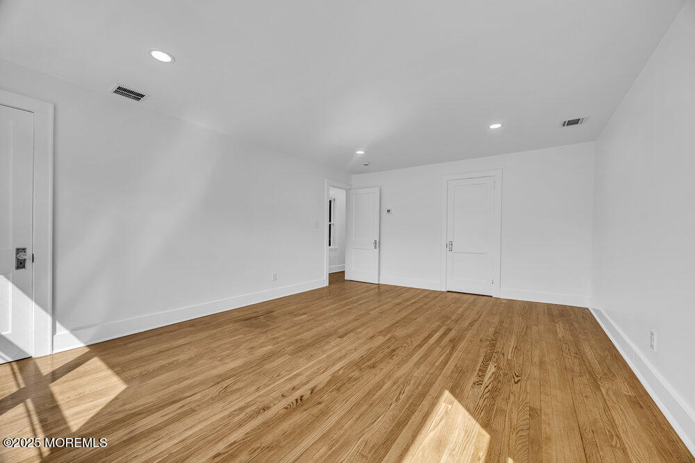 717 Holmdel Road Holmdel, NJ 07733 - Photo 24 of 39 a view of empty room with wooden floor