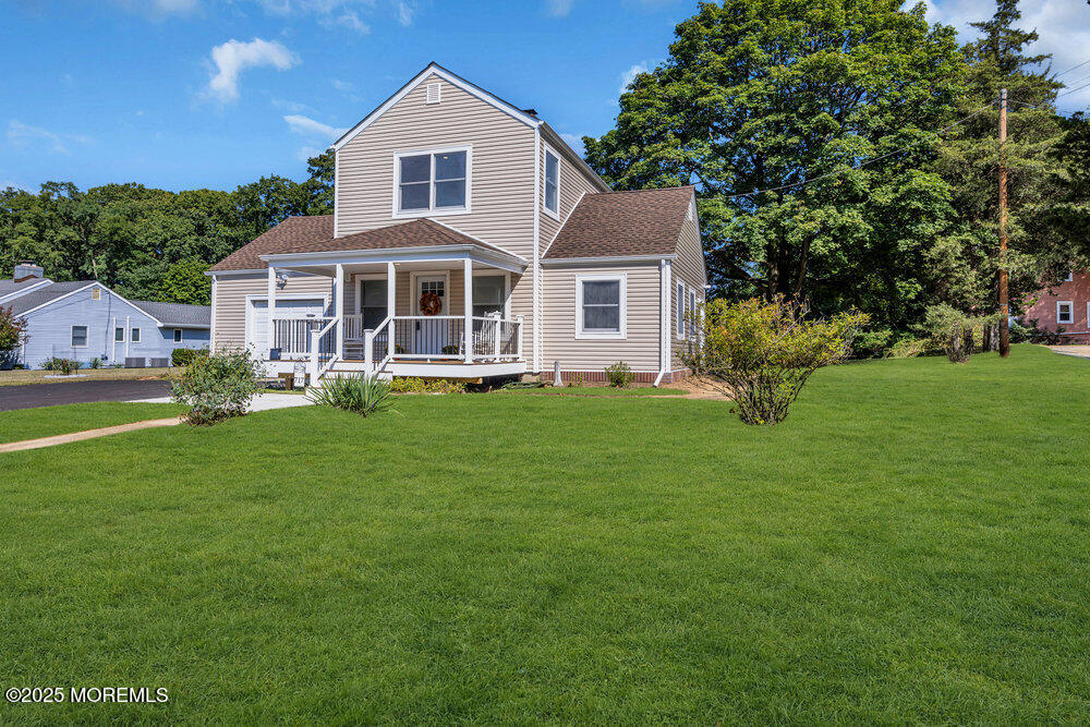 717 Holmdel Road Holmdel, NJ 07733 - Photo 3 of 39 a front view of a house with a yard and trees