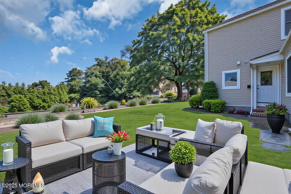 717 Holmdel Road Holmdel, NJ 07733 - Photo 33 of 39 a view of a patio with couches potted plants and a big yard