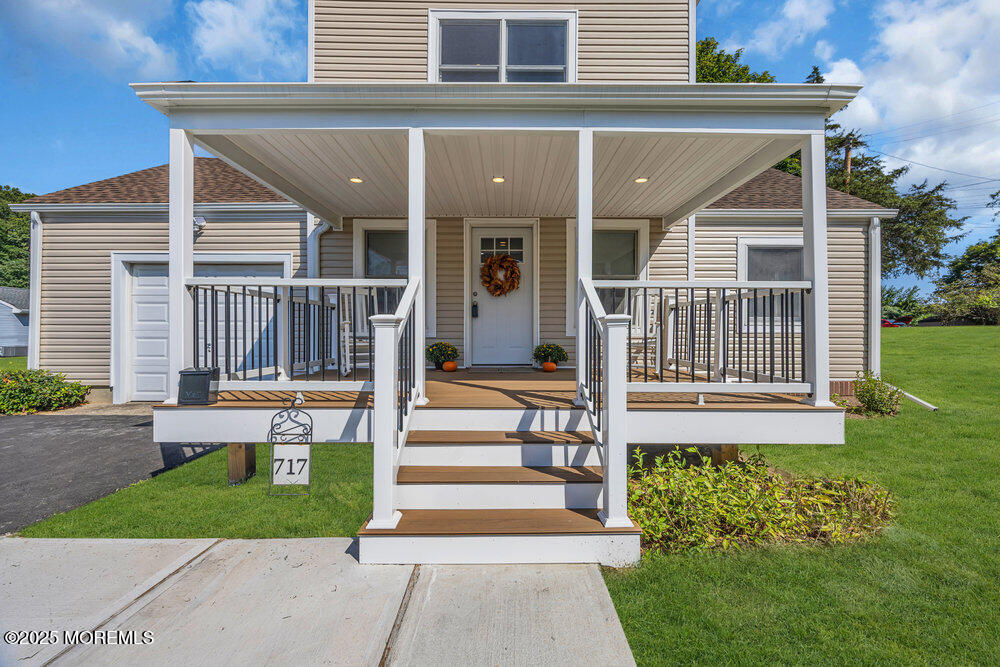 717 Holmdel Road Holmdel, NJ 07733 - Photo 5 of 39 a front view of a house with a garden and plants
