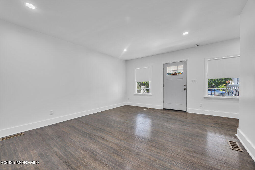 717 Holmdel Road Holmdel, NJ 07733 - Photo 9 of 39 an empty room with wooden floor and windows